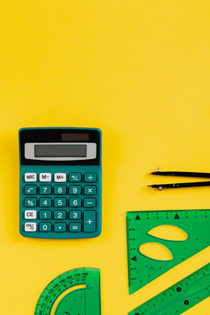 cta-01 A teal calculator and green geometry tools on a vibrant yellow backdrop.