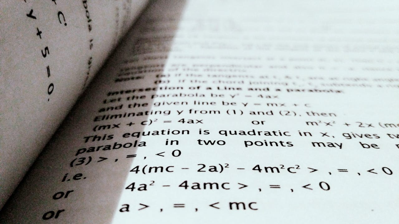 hero-gallery-04 A close-up shot of mathematical equations on a book page, perfect for education and learning concepts.